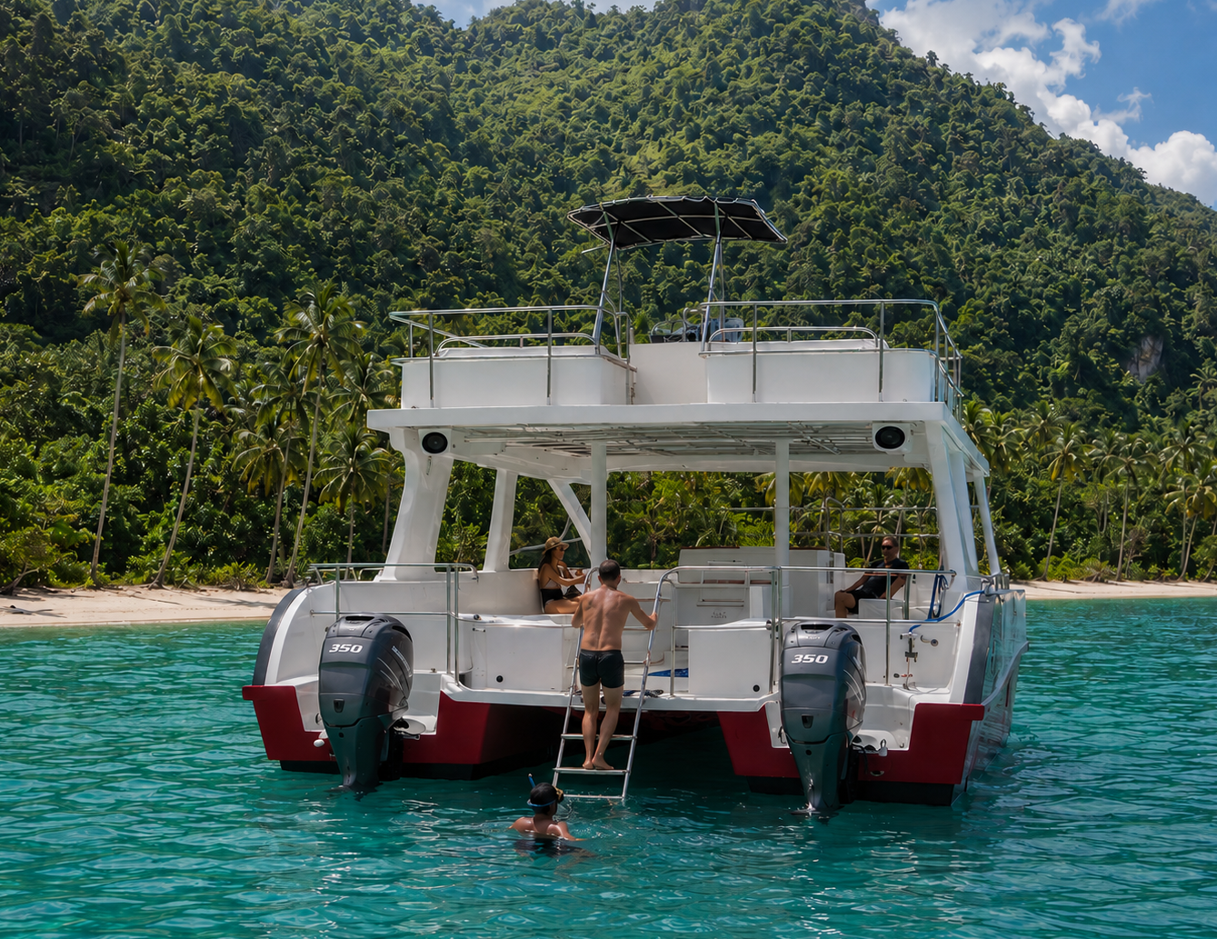 Full-day Jackson Bay snorkeling escape Guest boarding Antares from the water at Jackson Bay’s tropical coastline