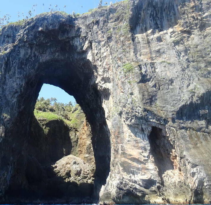 Dramatic natural rock arch along the coast of Cabo Cabrón National Park